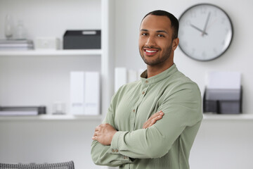 Wall Mural - Portrait of handsome young man indoors, space for text