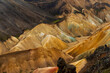 Multicolored mountains seen in Landmannalaugar, a location in Iceland's Fjallabak Nature Reserve in the Highlands, an area known for its natural geothermal hot springs and surrounding landscape.