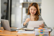 © Thitisak - Asian businesswoman working on documents at office