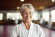 Portrait of happy senior retired woman at karate course