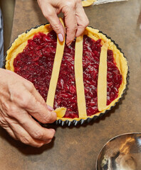 Wall Mural - Chef makes cherry pie in his home kitchen