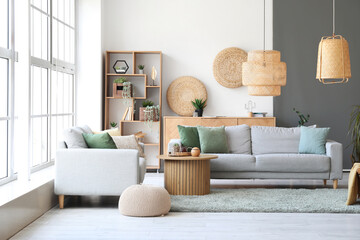 Interior of stylish living room with cozy grey sofas and coffee table on soft carpet