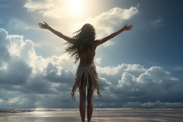 Wall Mural - A woman standing on a beach with her arms outstretched. This picture captures a moment of freedom and serenity. It can be used to depict relaxation, vacation, or the joy of being in nature