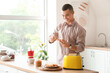 © Pixel-Shot - Young man making toast with tasty nut butter in kitchen