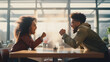 a young black couple engages in a heated argumentin a coffee shop, their faces contorted with emotion as they raise their voices in frustration. 