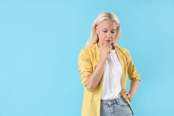 Poster - Thoughtful mature woman on blue background