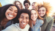 © BlazingDesigns - Group of multiracial young student people smiling and taking a selfie together outdoors.