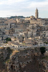 Wall Mural - Panoramic view of Sassi di Matera a historic district in the city of Matera, well-known for their ancient cave dwellings from the Belvedere di Murgia Timone,  Basilicata, Italy