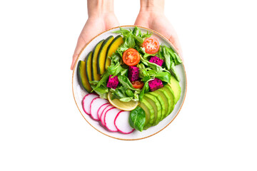 Wall Mural - Vegan salad with vegetables and fruits on plate holding by hand, Healthy food