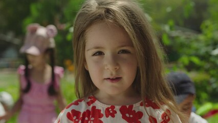 portrait of beautiful and adorable kid . girl face in park close up. portrait little child girl look