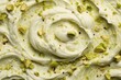macro texture swirl of green pistachio ice cream with nuts.