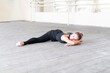 © Mihail - young female ballet dancer doing leg-split on the floor