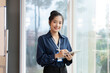 Asian female employee, smile and holding digital tablet, standing meeting room at office