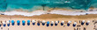 © kichigin19 - aerial panorama drone view beach line surf umbrellas and sun beds on the sand.