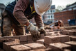© Davivd - A construction worker is seen placing bricks as he works on building a new residential structure