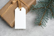 Blank gift tag mockup with copy space on christmas gift box, white tag card with space for text