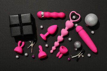 Sticker - Sex toys with Christmas decorations on a dark background.