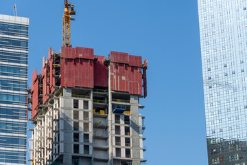 Wall Mural - Construction site with cranes on sky background.