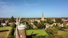 Thaxted Windmill And Church Flying Left .Thaxted Is A Popular Tourism In Essex, UK, Famous For Its Traditional Architecture And Cultural Festivals.