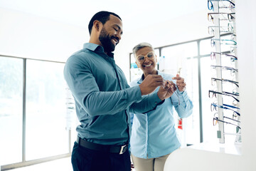 Poster - Optometry, glasses and woman and man for decision, choice and eye care option in optician store. Healthcare, ophthalmology and people in clinic to choose prescription lens, spectacles and frames