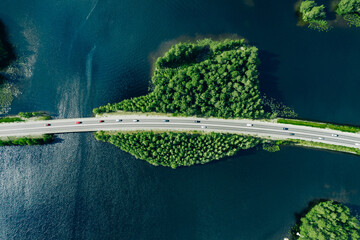 Wall Mural -  Aerial view of bridge road through blue lakes with green woods in Finland.