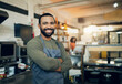 © N F/peopleimages.com - Happy man, portrait and small business owner in kitchen at restaurant for hospitality service, cooking or food. Face of male person, employee or waiter smile in confidence for professional culinary