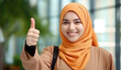 © marimalina - Muslim Indonesian Asian woman in hijab showing thumbs up