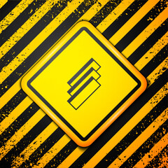 Wall Mural - Black Cigarette rolling papers pack icon isolated on yellow background. Warning sign. Vector