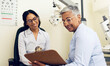 © N F/peopleimages.com - Optometrist, patient and eye exam, clipboard and health insurance paperwork, help and medical with eyecare. Wellness, contract or agreement with vision, assessment and women in clinic for optometry
