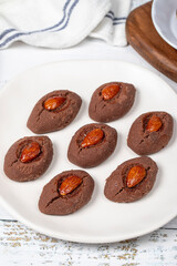 Wall Mural - Almond cookies. Cookies with cocoa and almonds on a white wooden background. patisserie products