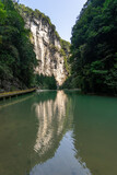 Fototapeta Miasto - Water reflection of high towering cliff in Wulong krast national geology park, Chongqing, China