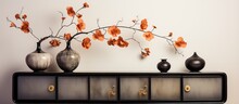 Begonia Maculata Placed With Dried Poppy Seed Pods In Golden Vase On Vintage Sideboard