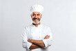 © Natalya - smiling middle-aged European chef in a white uniform with a gray beard, on a white background
