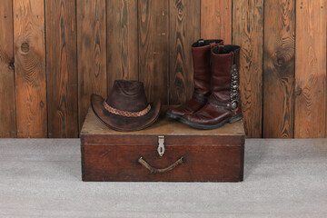 Canvas Print - cowboy hat, boots and suitcase on wooden floor