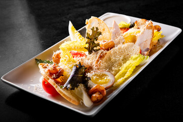 Wall Mural - Caesar salad with croutons, cheese, eggs, tomatoes and grilled chicken