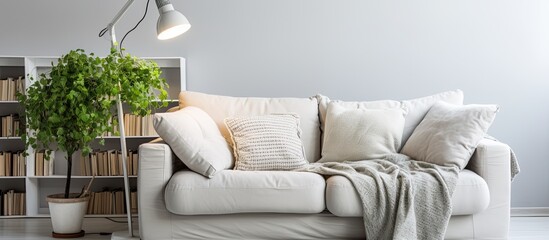 Wall Mural - Woman reading book on grey sofa at home With copyspace for text