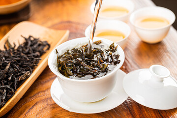 Brewing Chinese tea in ceramic gaiwan during the tea ceremony close-up.