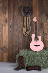 Canvas Print - guitar and cowboy boots in the barn