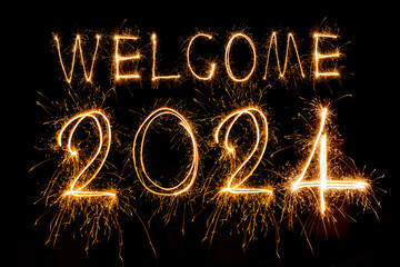 Wall Mural - Happy New Year 2024. Sparkling burning text Happy New Year 2024 isolated on black background.