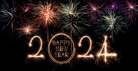 Wall Mural - Happy New Year 2024. Sparkling burning text Happy New Year 2024 isolated on black background.