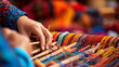 A close-up of hands expertly weaving a colorful ethnic folk rug, Ethnic Folk, blurred background