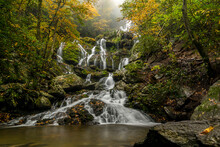 Waterfall In Autumn With Fall Foliage