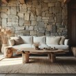White sofa and hand crafted coffee table against stone cladding wall. Rustic home interior design of modern living room