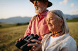 Portrait of a senior woman looking through binoculars. Elderly spouses going mushroom picking.