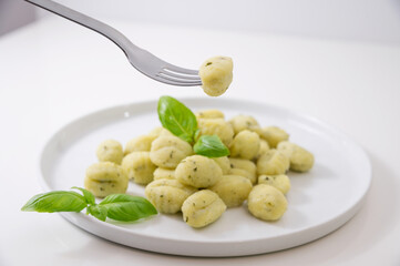 Wall Mural - Italian gnocchi. Traditional Italian food. Handmade potato balls with parmesan and basil. Food for vegetarians and lovers of Italian typical cuisine. homemade pasta . High quality