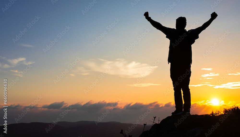 Silhouette of positive man standing on top of the mountain peak with ...