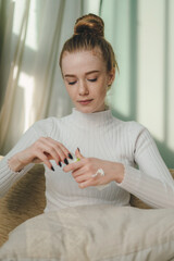 Wall Mural - young woman squeeze out cream on her hands, makeup routine in the morning at home. facial beauty.