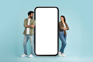 Poster - Multiracial man and woman standing by big phone with mockup