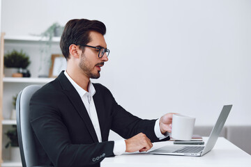 Man in office businessman sitting at desk and working in laptop, finance and startup concept, working lifestyle in bright office.