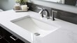 Closeup of a vitreous china sink with a glossy white surface and a smooth, modern design. Its clean and minimalistic look is complemented by its strength and durability, making it a popular